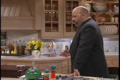 a man in a suit standing in a kitchen