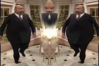 two bald men in suits are standing in front of a mirror