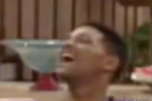 a blurry photo of a man with a drink in his mouth