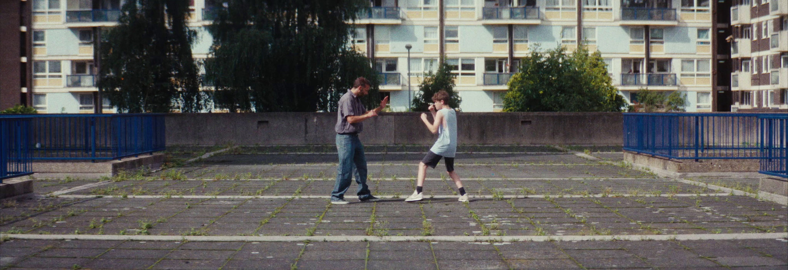 a man and a woman standing in a parking lot