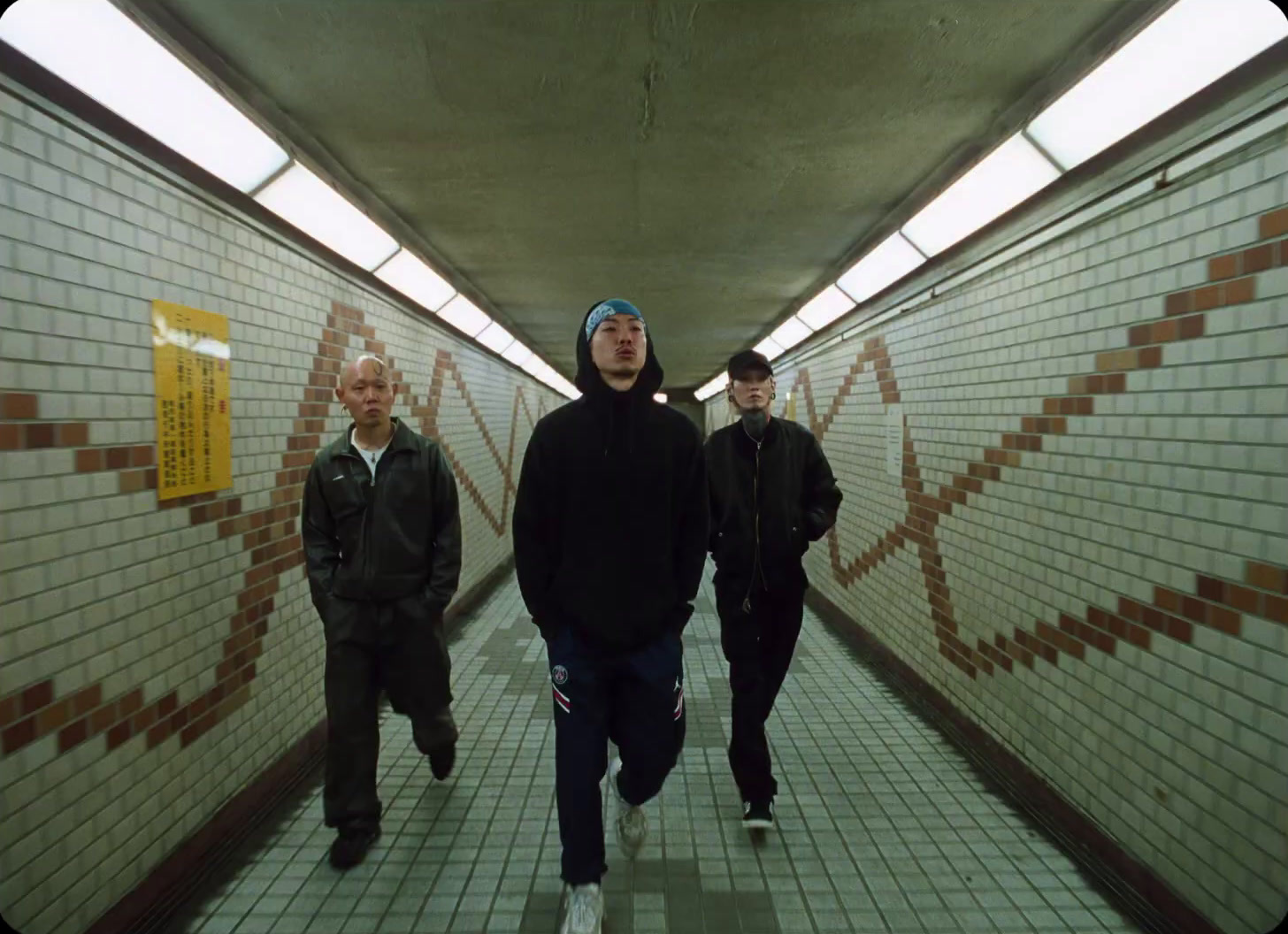 a group of men walking down a long hallway