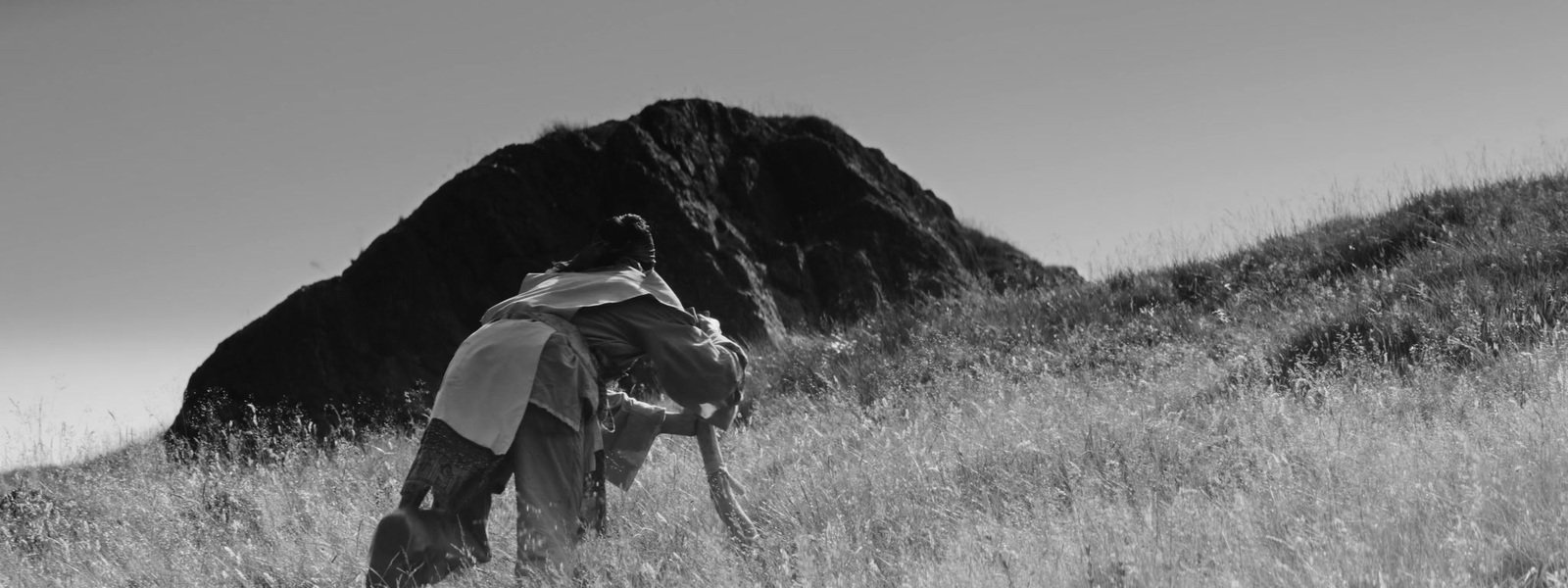 a black and white photo of a person in a field