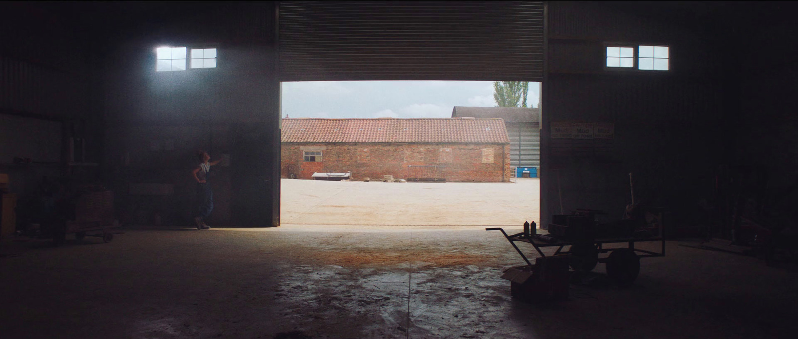 an open garage door with a person standing in the doorway