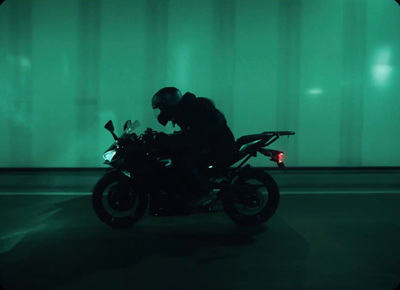 a man sitting on a motorcycle in the dark