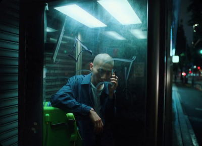 a man talking on a cell phone while sitting in a bus