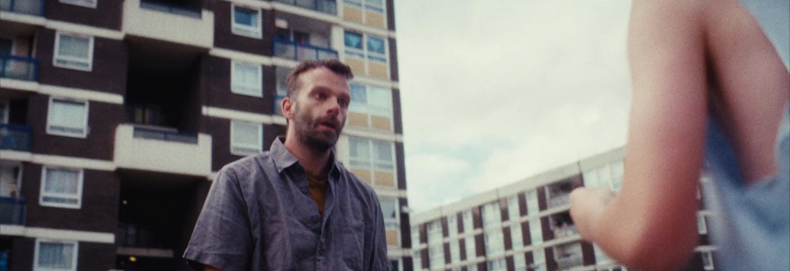 a man standing in front of a tall building