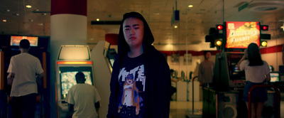 a young man standing in front of a store