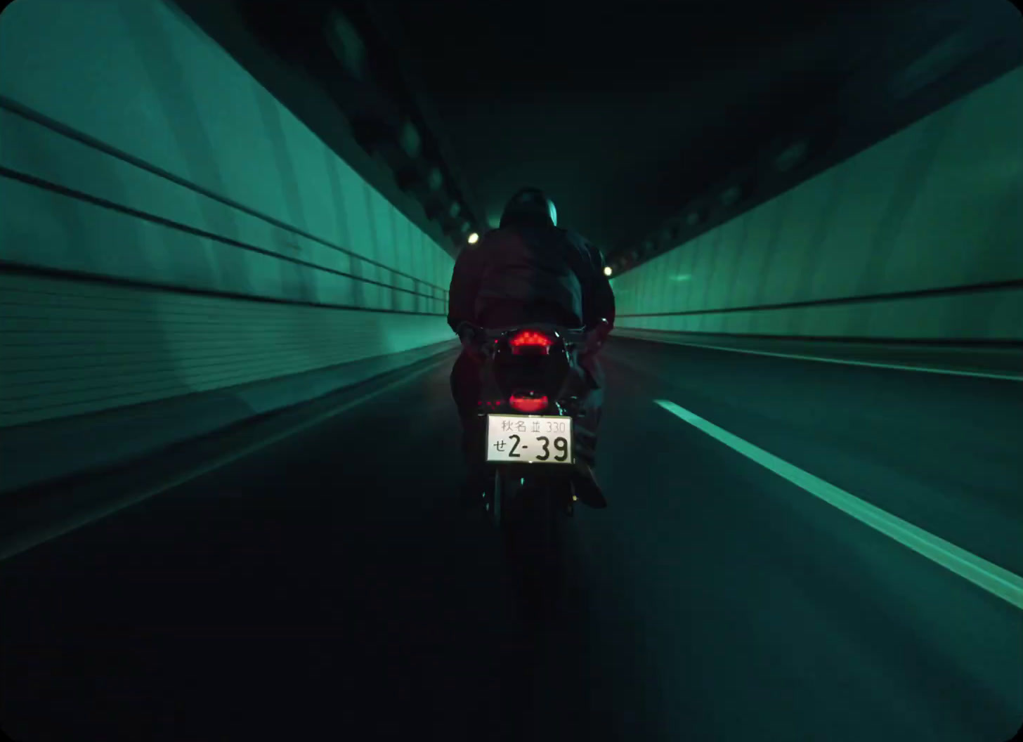 a person riding a motorcycle in a tunnel