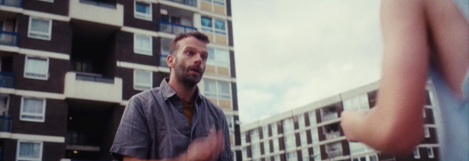 a man standing in front of a tall building