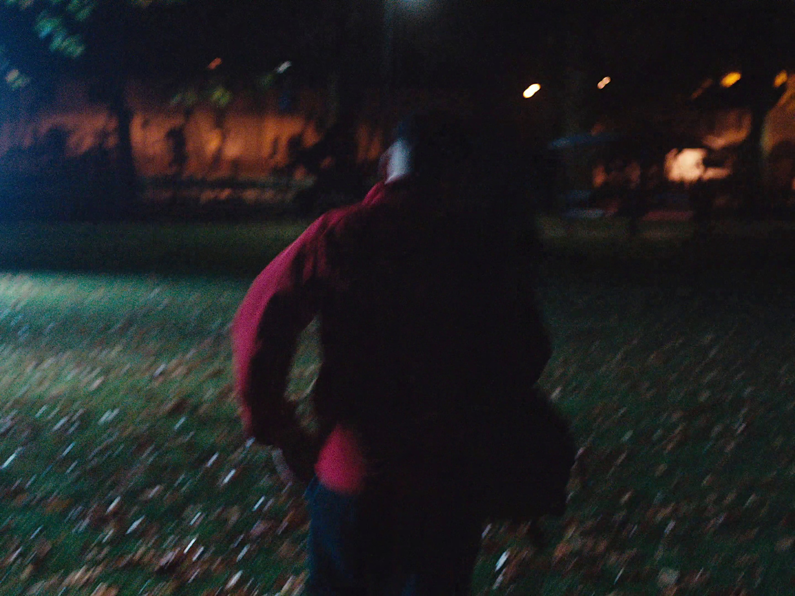 a blurry image of a person in a park at night