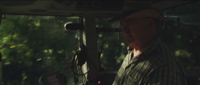 a man driving a bus in the woods