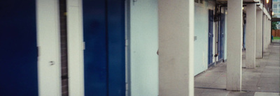 a row of blue and white doors on a building