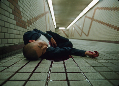 a young boy laying on the ground with his head on the floor