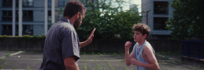 a man standing next to another man on a tennis court