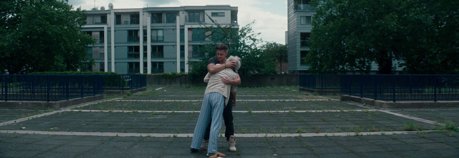 a man and a woman are hugging in a courtyard