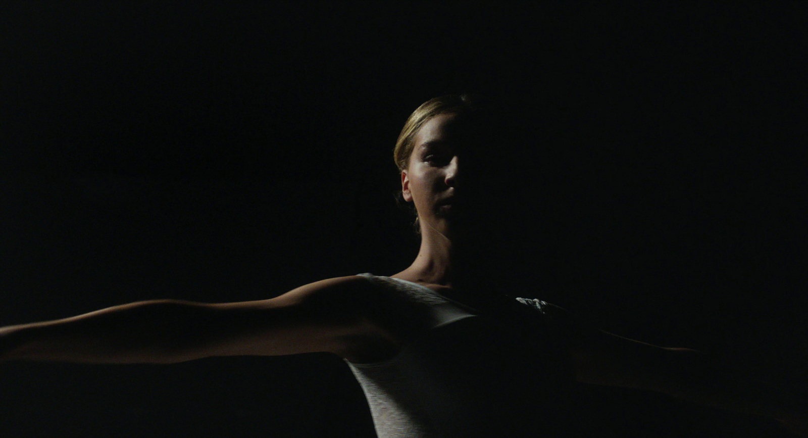 a woman in white shirt holding a tennis racquet