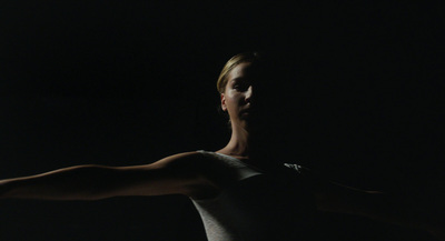 a woman in white shirt holding a tennis racquet