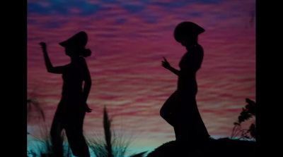 two silhouettes of a woman and a man standing in front of a sunset