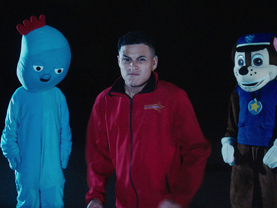 a man standing next to three cartoon characters