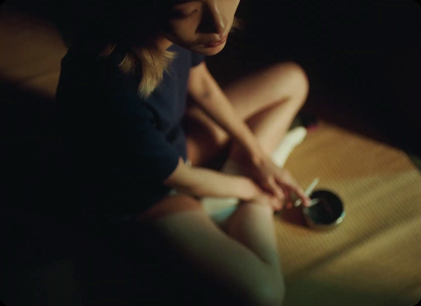 a woman sitting on the floor with a guitar