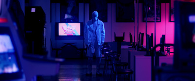 a man standing in front of a tv in a room