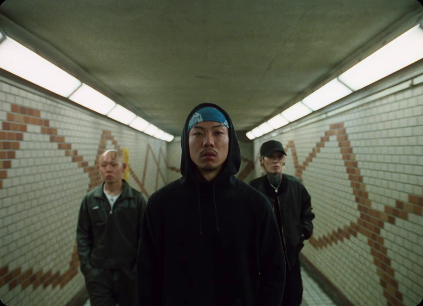 a group of men standing in a subway tunnel