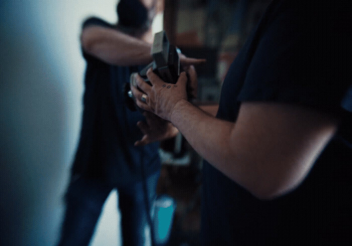 a man holding a gun in his right hand