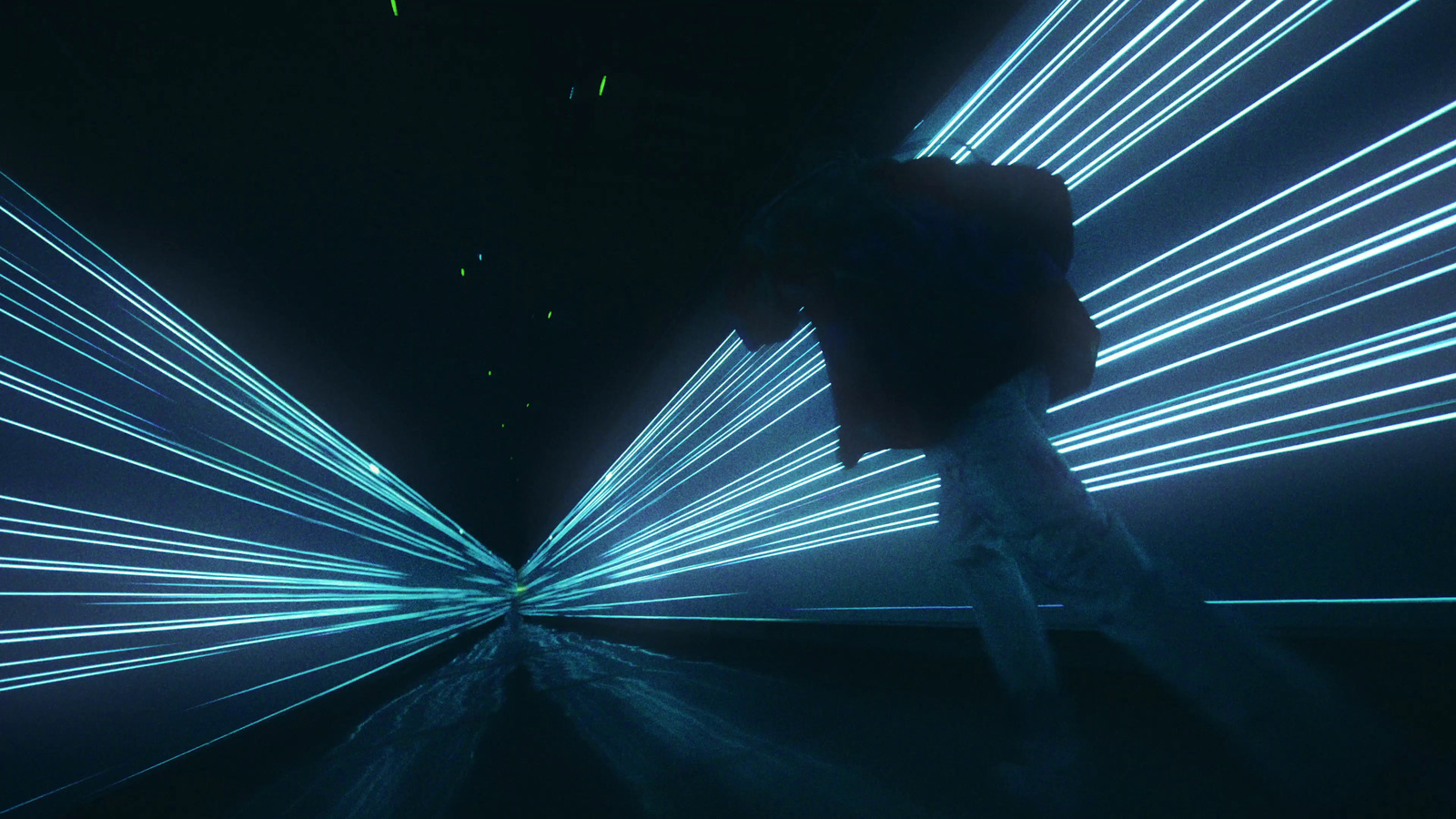 a man standing in front of a blue light