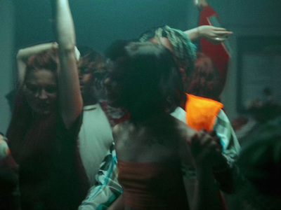 a group of people dancing in a dark room