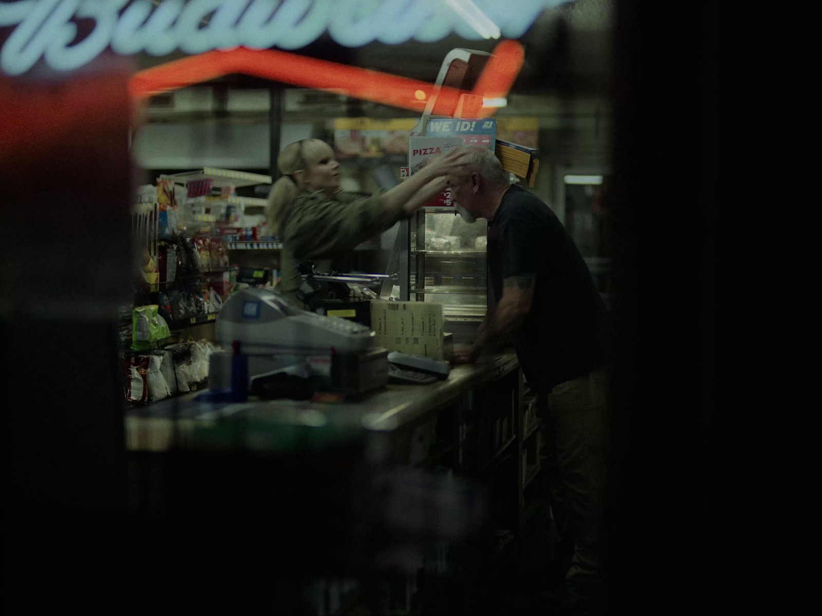 a man standing at a counter in a store