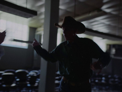 a man wearing a cowboy hat standing next to another man