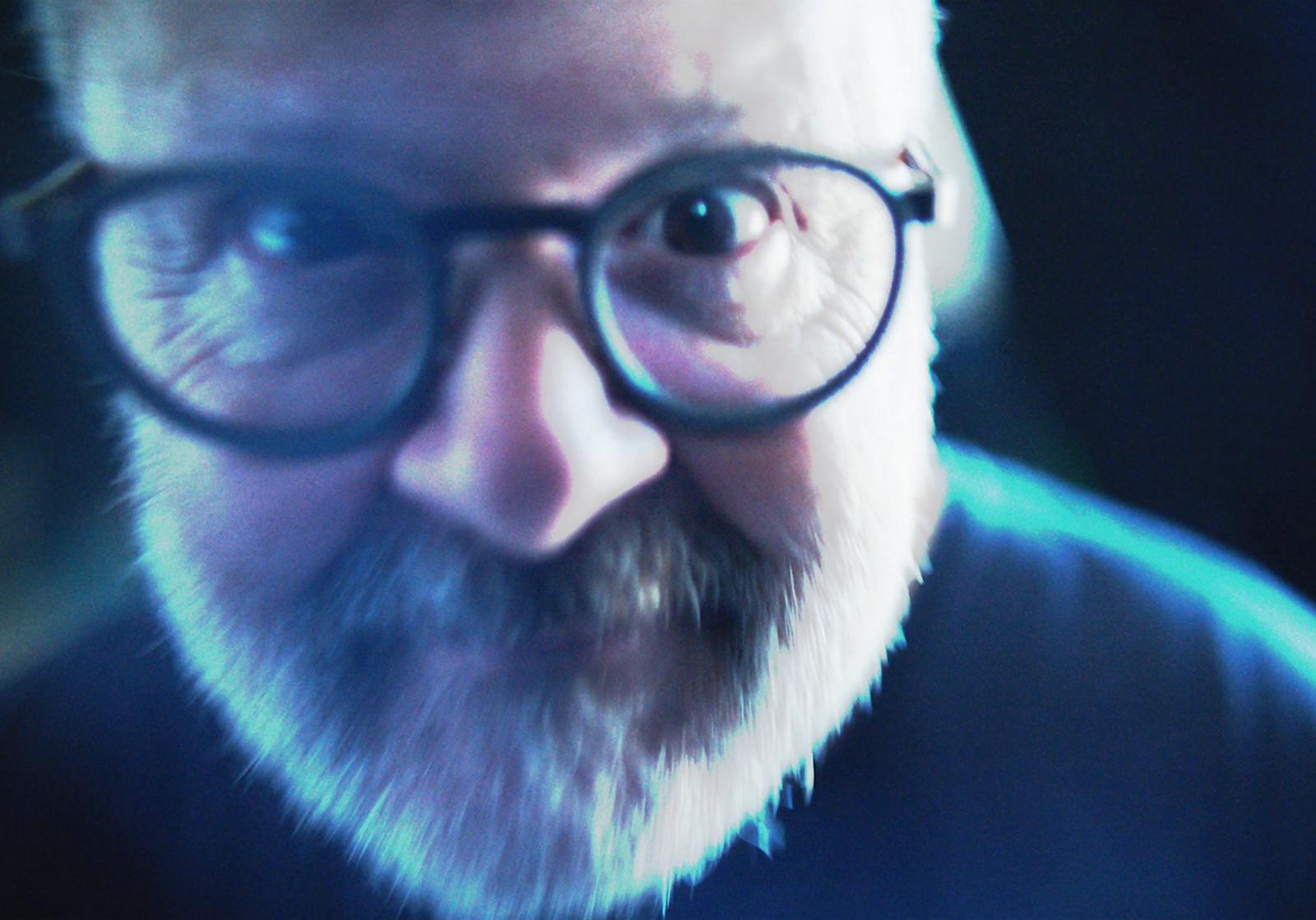 a close up of a man with glasses and a beard