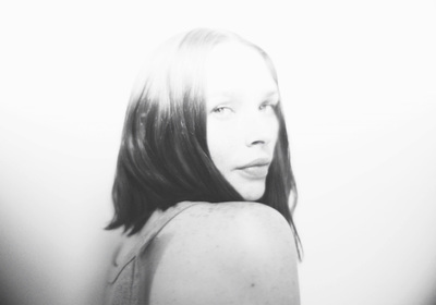 a black and white photo of a woman with long hair