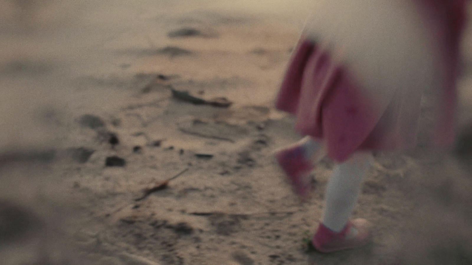 a blurry photo of a person walking on a beach