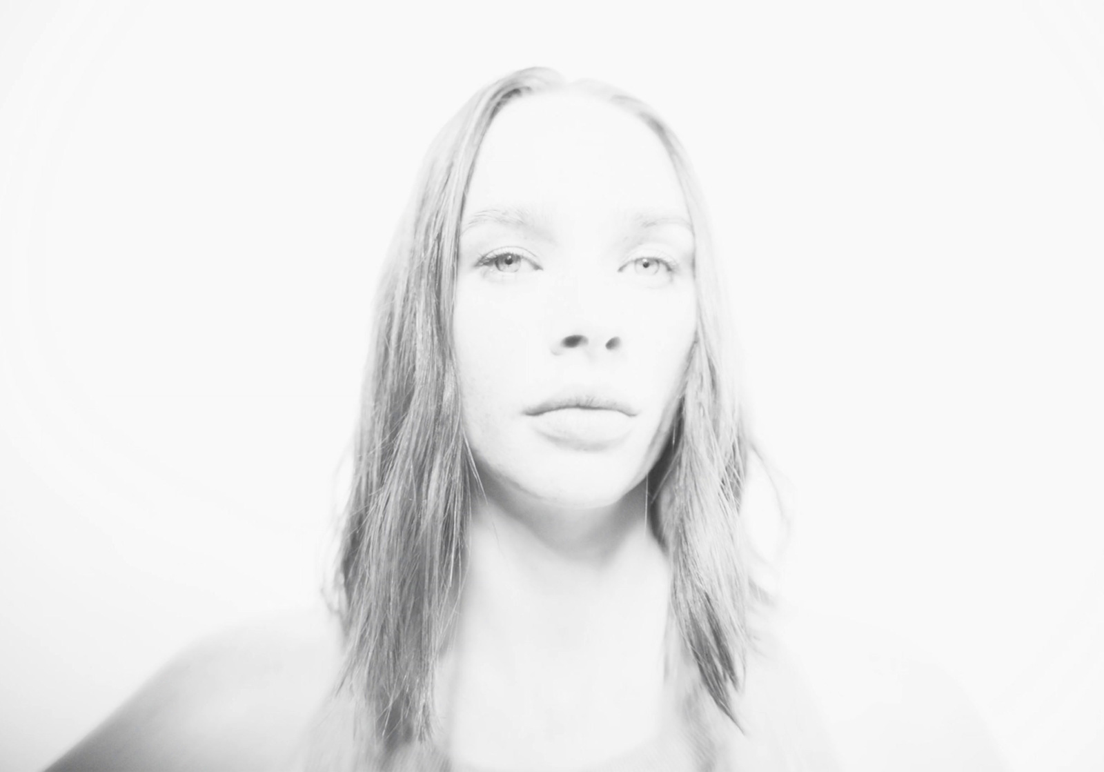 a black and white photo of a woman with long hair