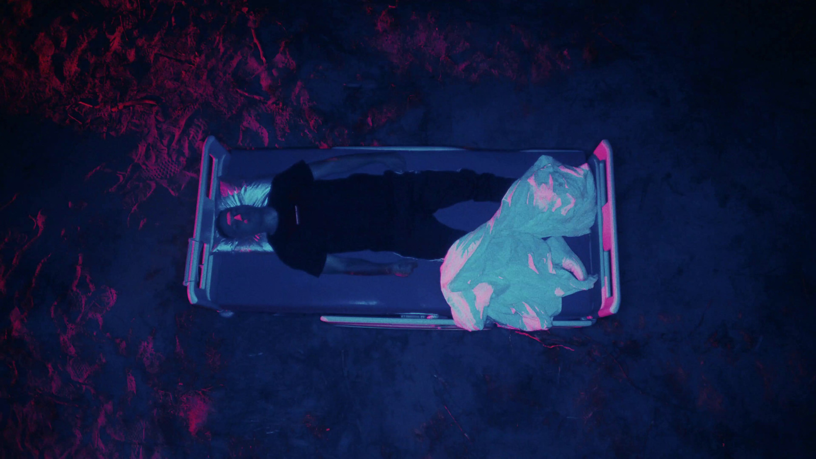 a person laying on the ground in a suitcase