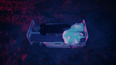 a person laying in a suitcase on the ground