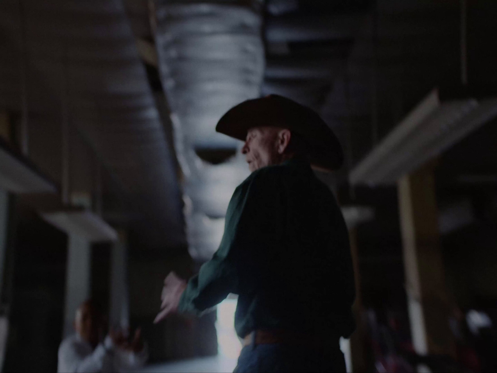 a man in a cowboy hat standing in a room