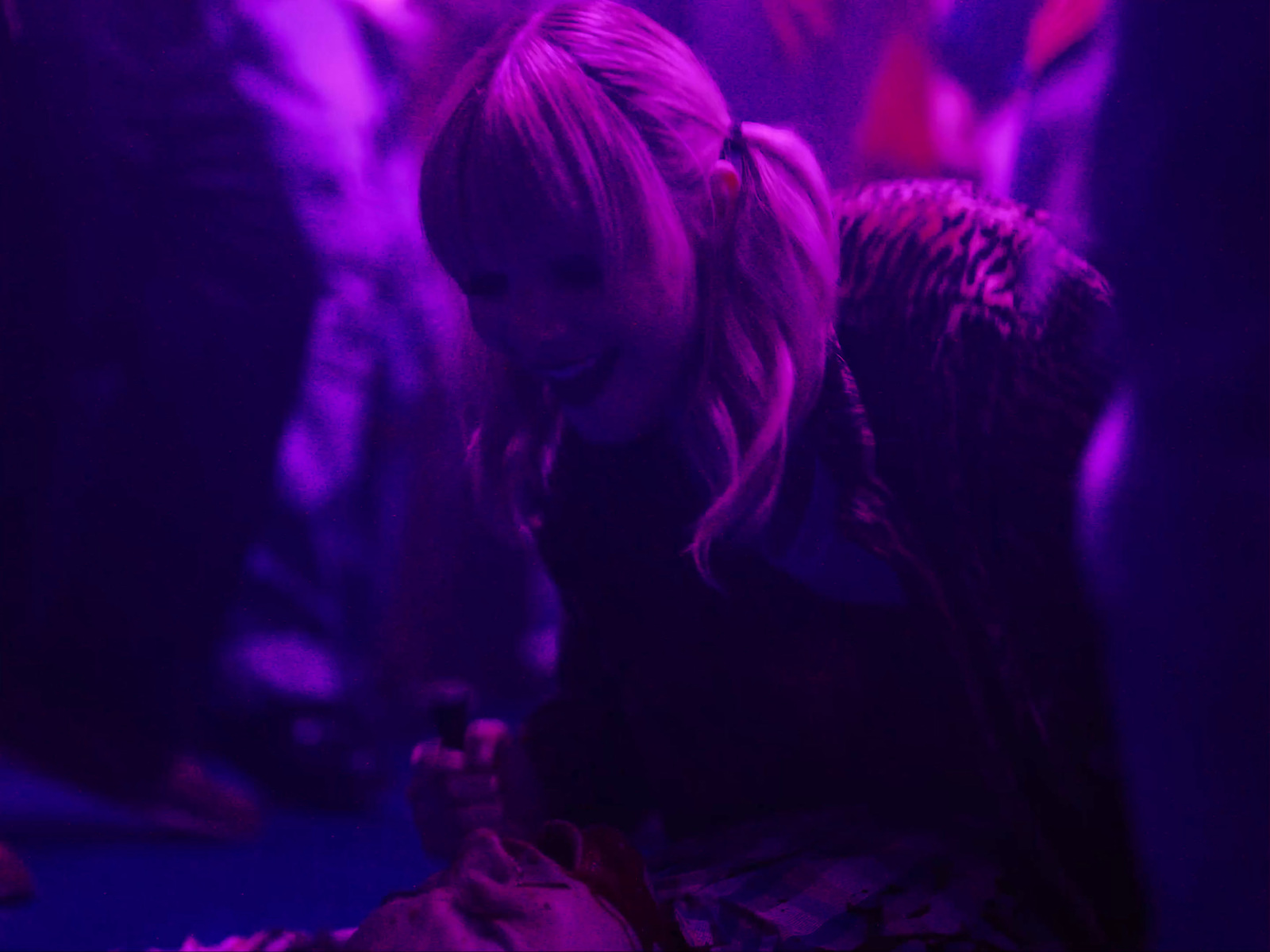 a woman sitting on the ground looking at her cell phone