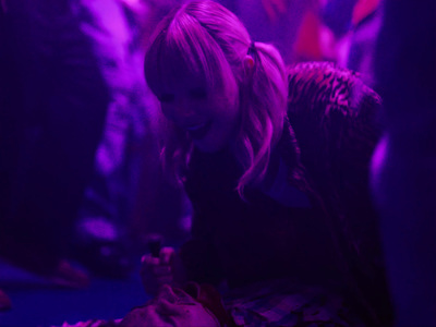 a woman sitting on the ground looking at her cell phone