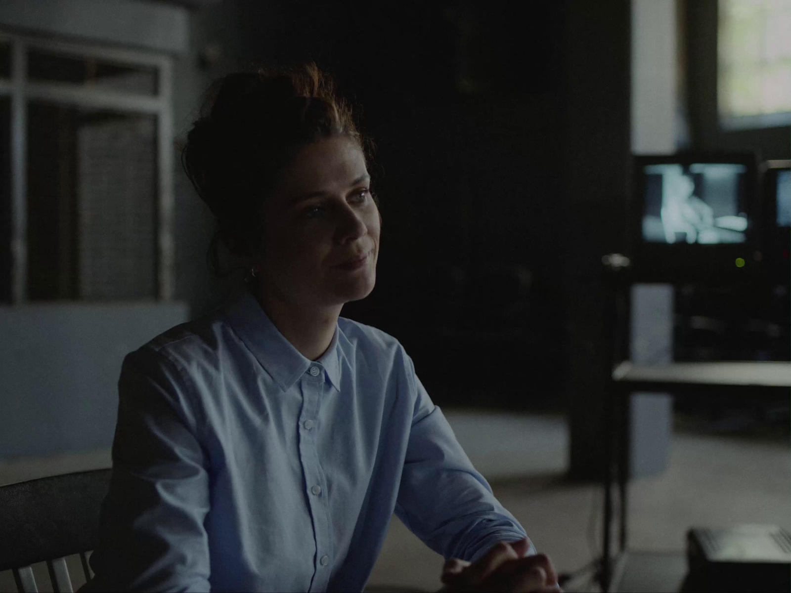 a woman sitting at a table in front of a computer