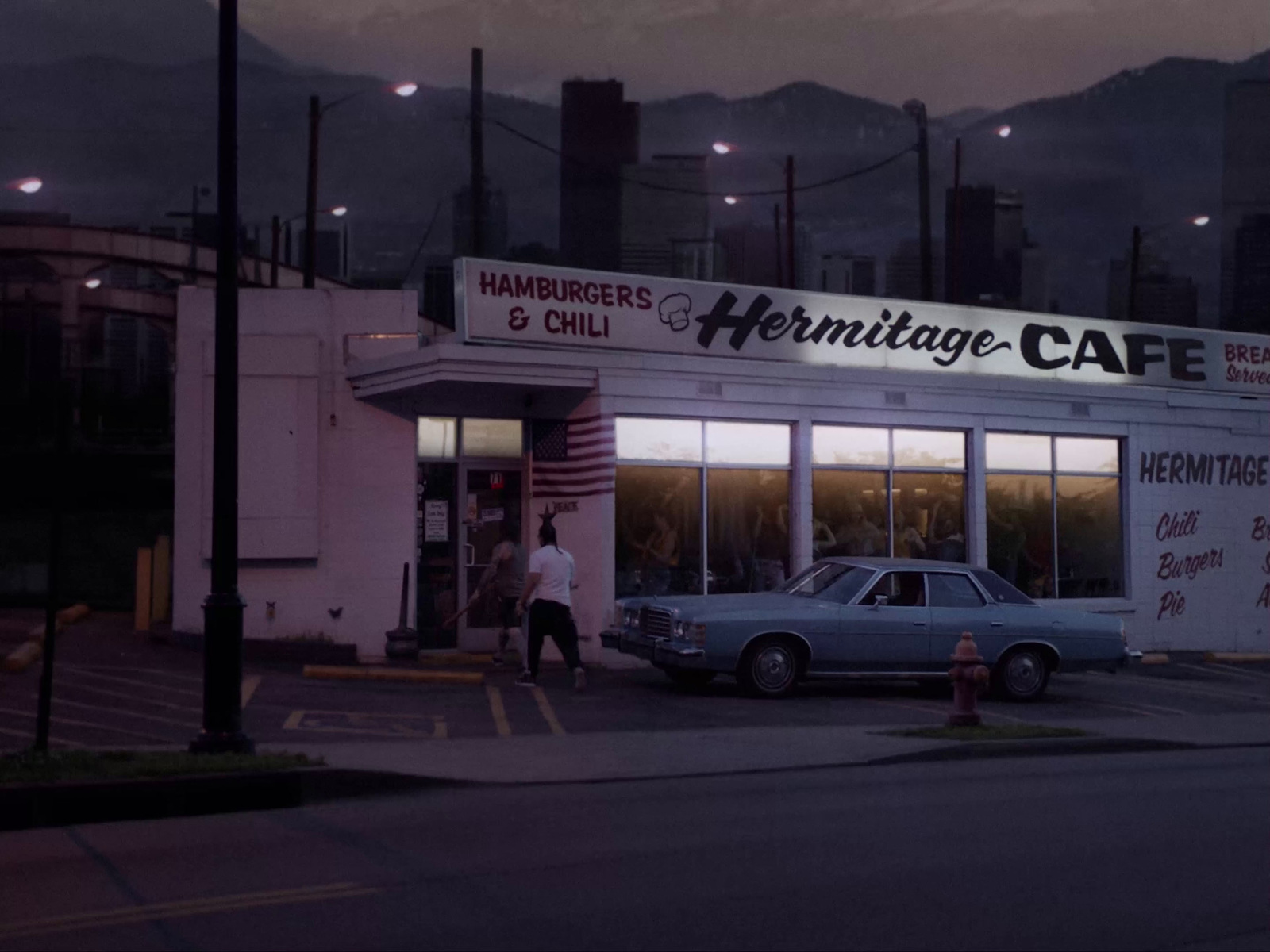 a car parked in front of a vintage cafe