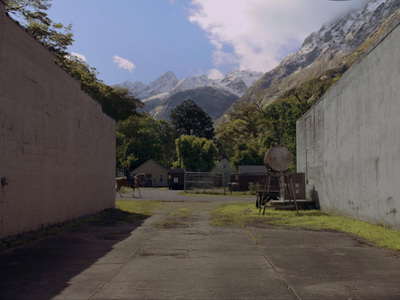 a view of a mountain range from an alley way