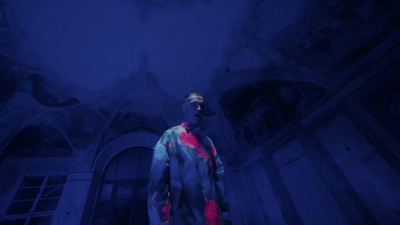 a man standing in a room with a blue ceiling