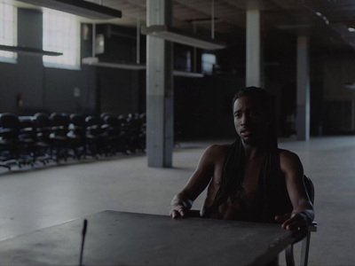 a woman sitting at a table in an empty room