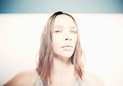 a woman with long hair is posing for a picture