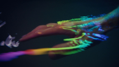 a person's hand with a multicolored design on it