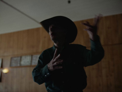 a man wearing a hat standing in a room