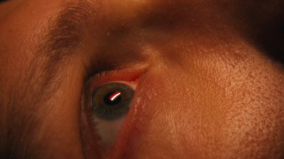 a close up of a person's eye with a red spot on the iris