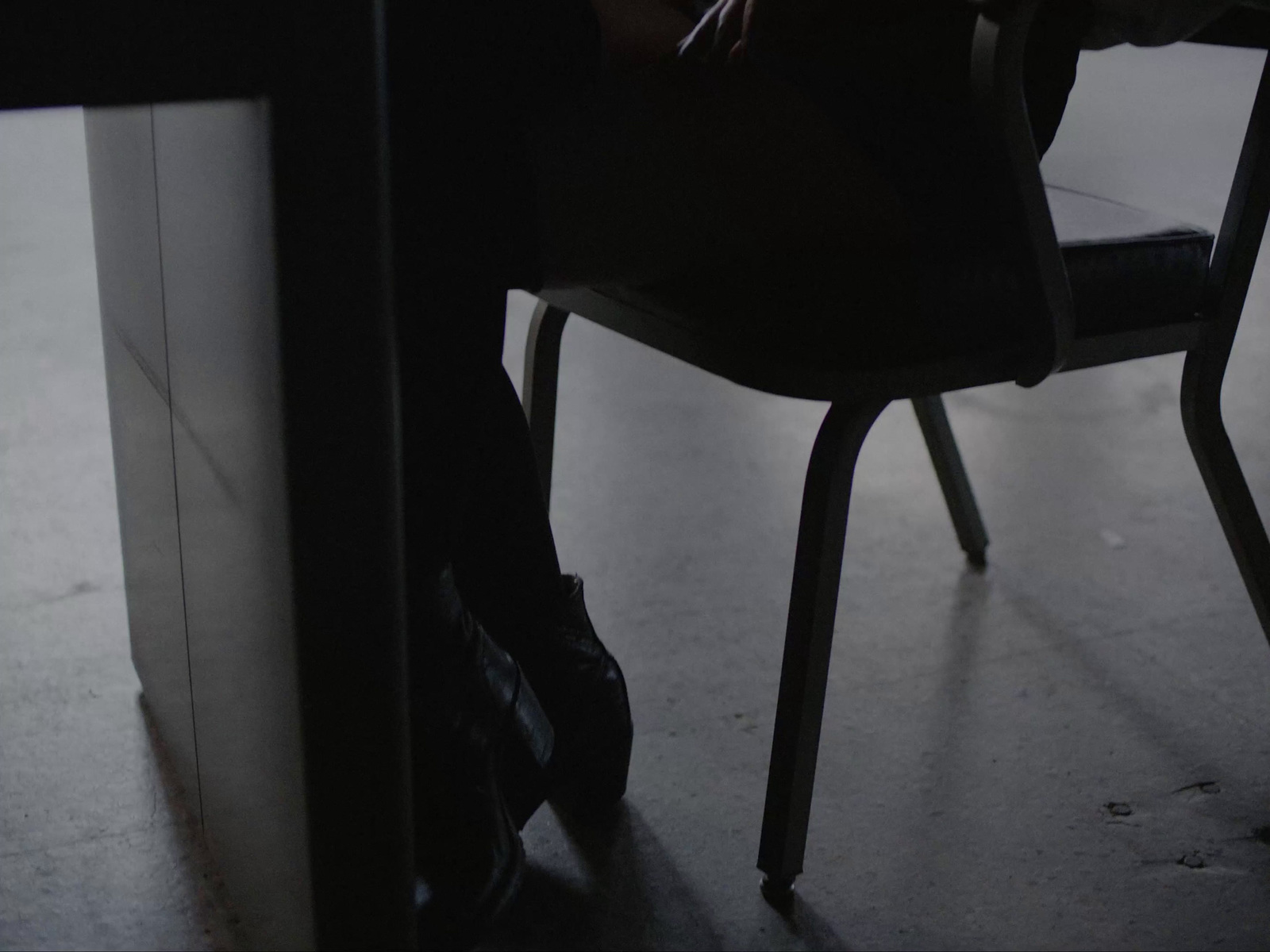 a person sitting at a table with a laptop